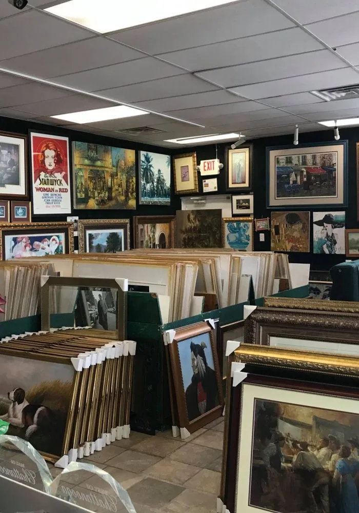 The salon-style gallery wall of framed art inside One Price Framing in Chattanooga